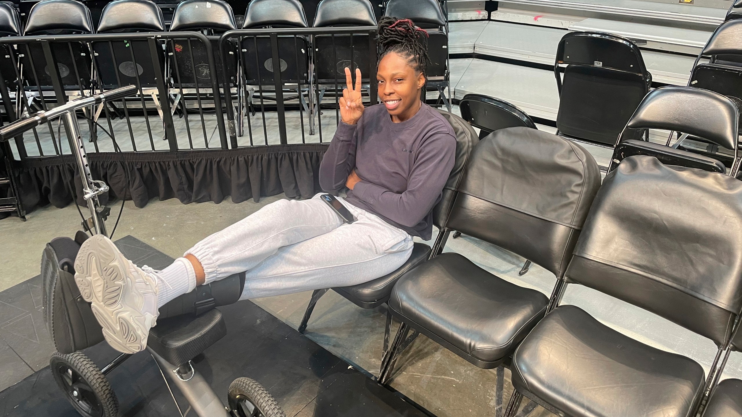Las Vegas Aces WNBA basketball player Chelsea Gray wears a boot during a team availability at Barclays Center in New York Tuesday, Oct. 17, 2023. Gray is out at least for Game 4 of the WNBA Finals against the New York Liberty after suffering an injury to her left foot Sunday. (AP Photo/Doug Feinberg)