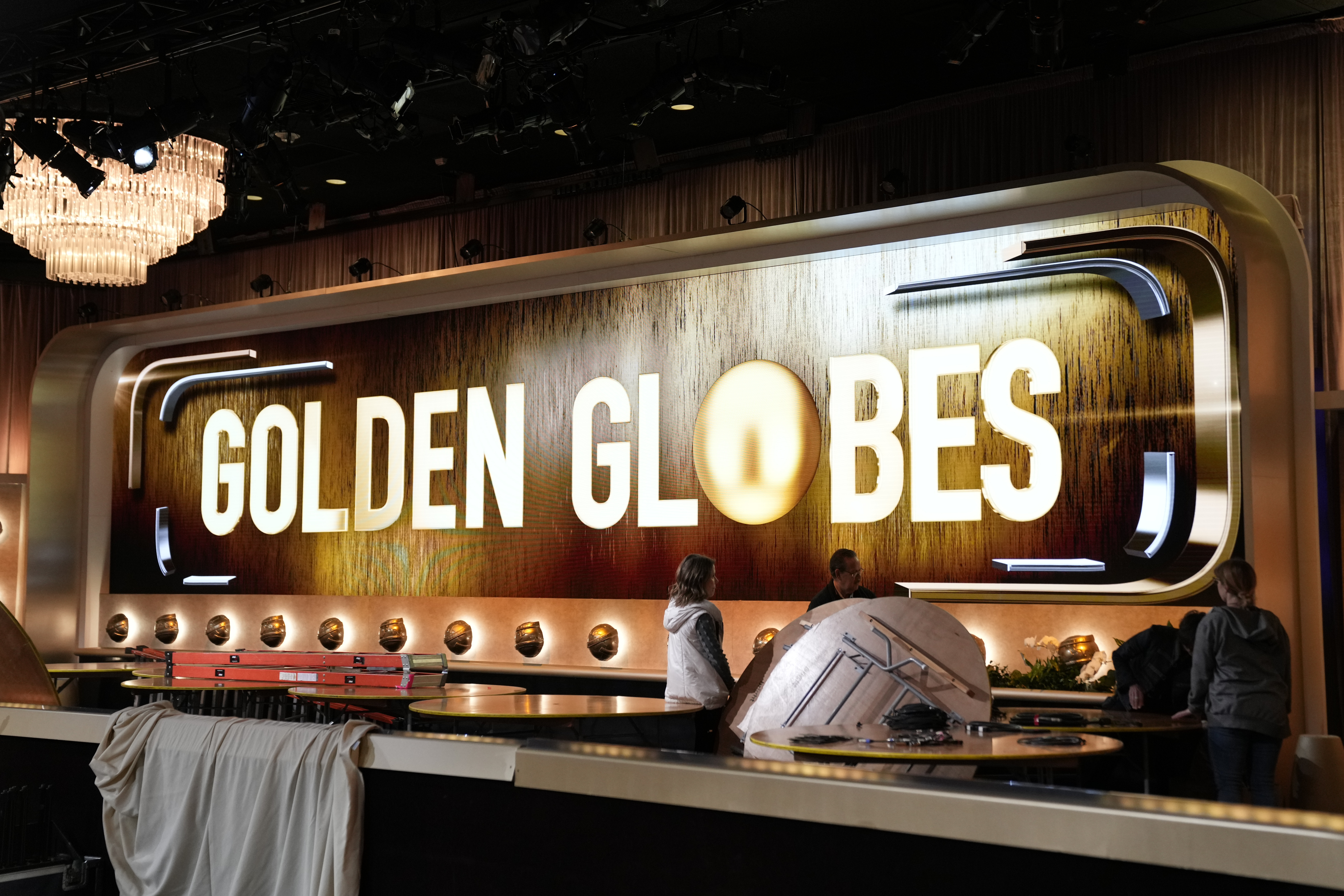 Crews set up a ballroom during the Golden Globe Awards Press Preview at the Beverly Hilton on Thursday, Jan. 4, 2024, in Beverly Hills, Calif. (AP Photo/Ashley Landis)