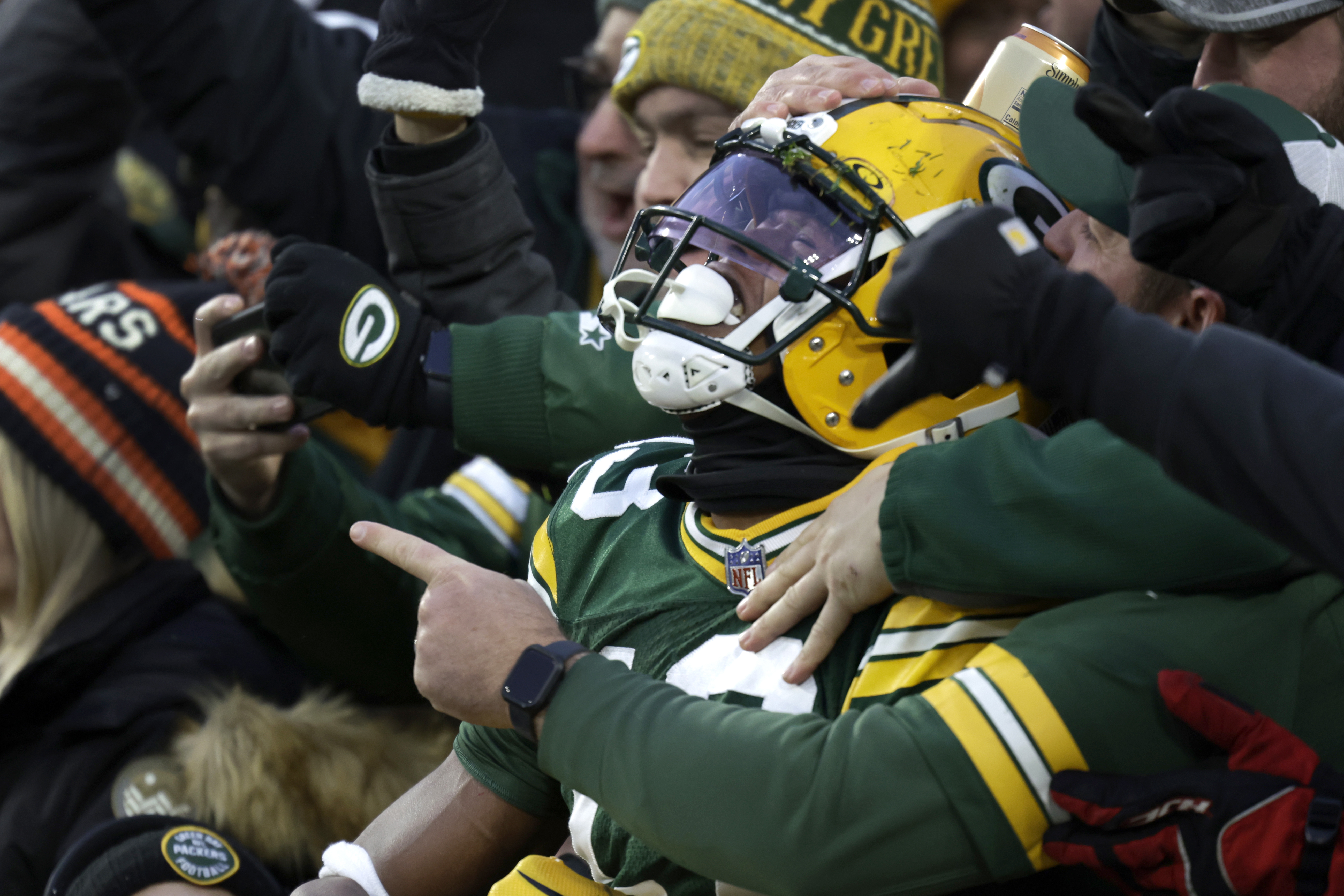 Green Bay Packers wide receiver Dontayvion Wicks celebrates after catching a touchdown pass during the first half of an NFL football game against the Chicago Bears Sunday, Jan. 7, 2024, in Green Bay, Wis. (AP Photo/Matt Ludtke)